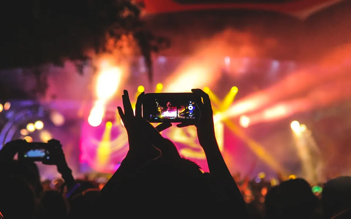 Fan filming a concert on their phone